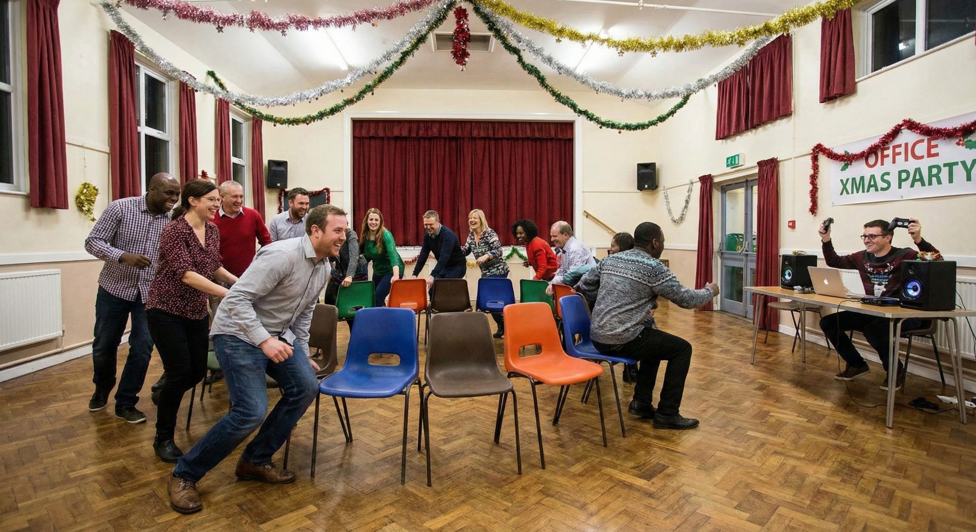 People excitedly running around chairs in a game of musical chairs, with Christmas music playing and a game controller